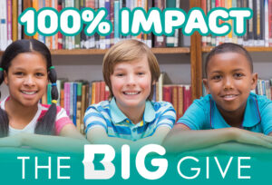 Image showing three smiling children in front of a library book shelf with the text 100% IMPACT and The BIG Give superimposed over it.